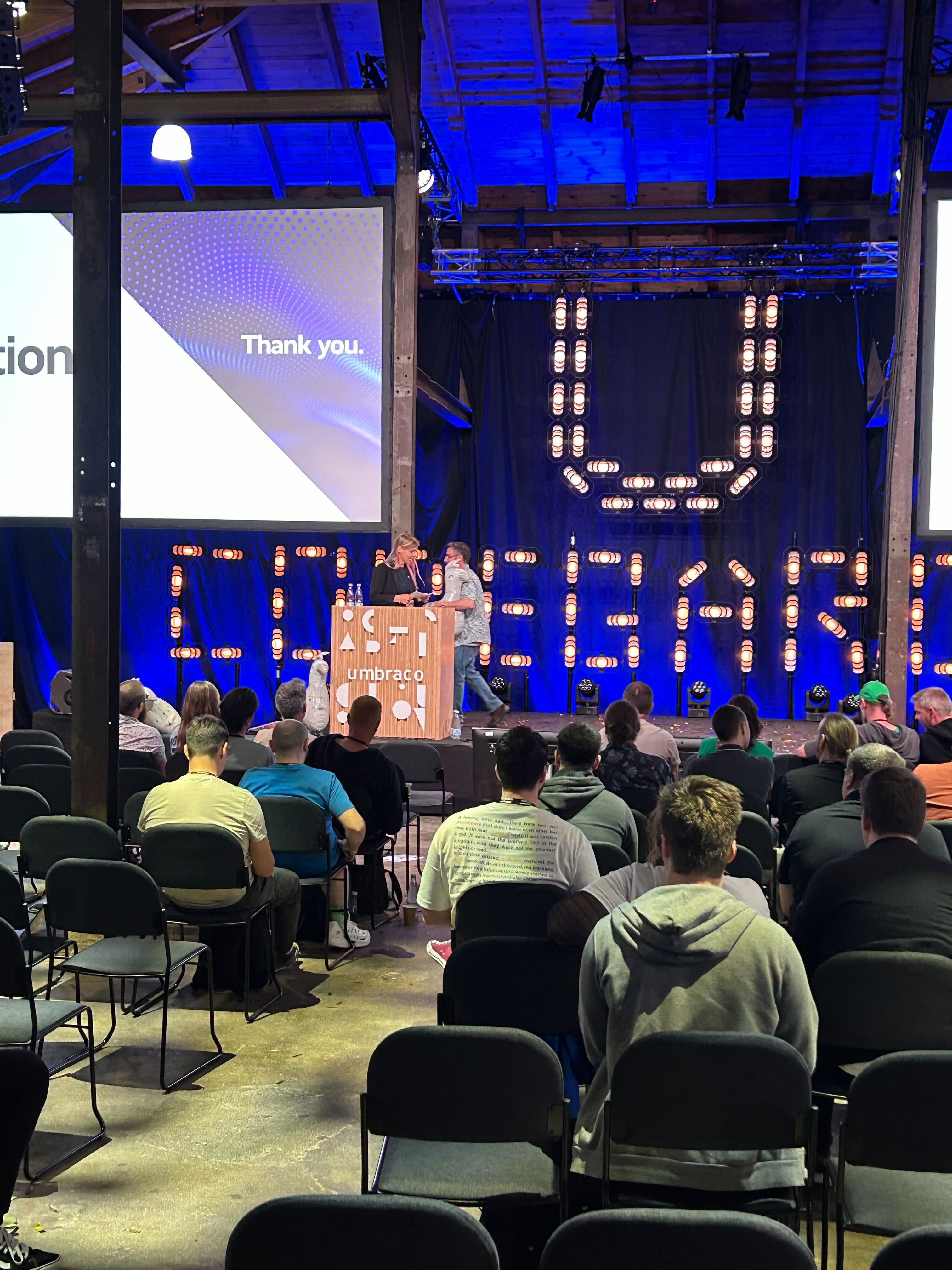 Vibrant stage at Codegarden event, set with professional lighting and presentation screens.